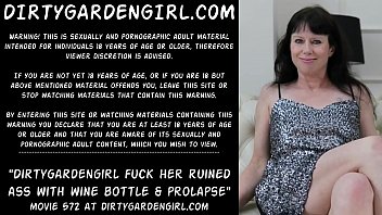 Dirtygardengirl fucking her ruined ass with two wine bottles big and bigger. Then prolapse